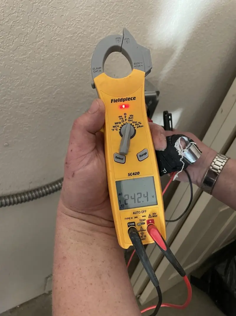 Voltage testing with clamp meter during Outlet Installation in Elmendorf